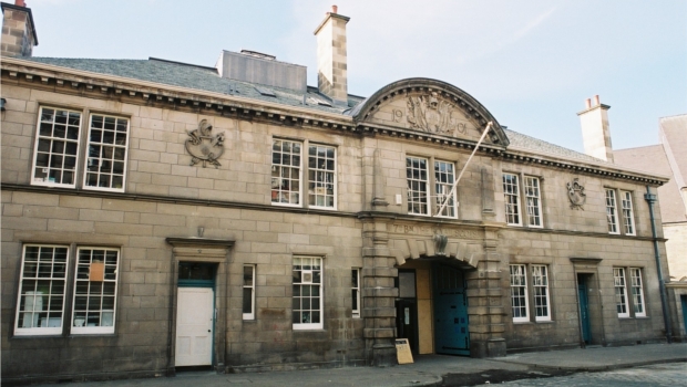 The exterior and large front doors of the Out of the Blue Drill Hall, designed in 1915.