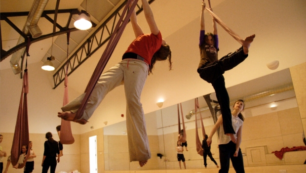Aerialists in the Rehearsal Room practising acrobatics for an upcoming theatre performance.