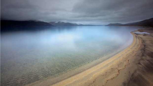 Photograph of a beach at a lakeside, by Ian Preece