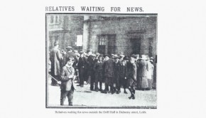 A large, worried crowd gathers outside the Army Drill Hall awaiting the news of local soldiers involved in the Quintinshill Rail Disaster near Gretna, 1915 with the newspaper headline 'RELATIVES WAITING FOR NEWS'.