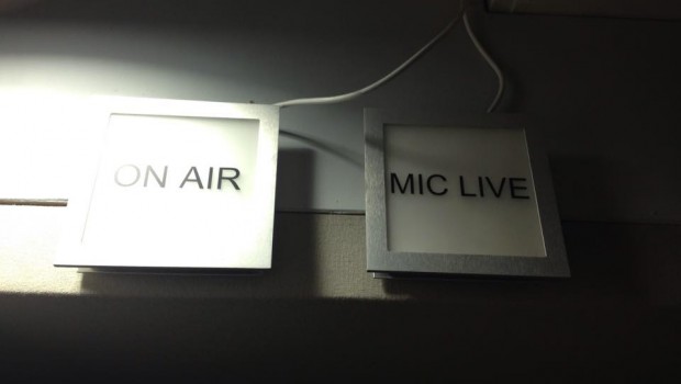 Signs above the recording studio flash 'On Air'.