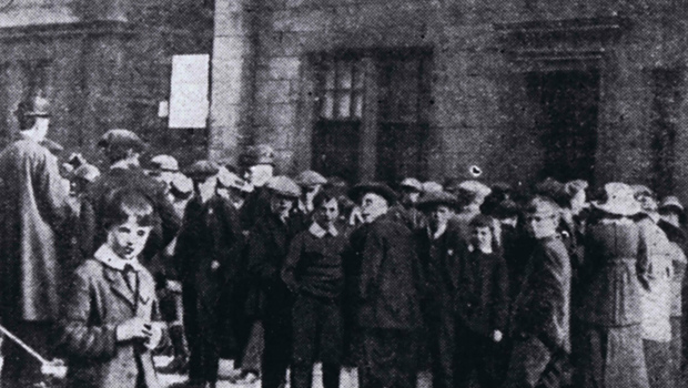 A large, worried crowd gathers outside the Army Drill Hall awaiting the news of local soldiers involved in the Quintinshill Rail Disaster near Gretna, 1915