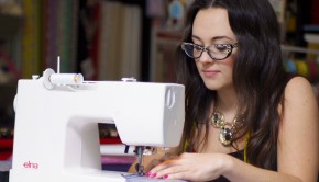 A woman uses a sewing machine at a 'Sew Confidence' class