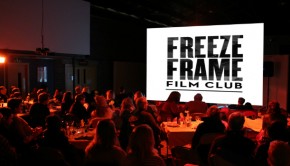 A group of people look at a cinema screen at a Freeze Frame Film Club night