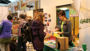 A stallholder chats to a customer about books at the Edinburgh Greenpeace Eco Fair