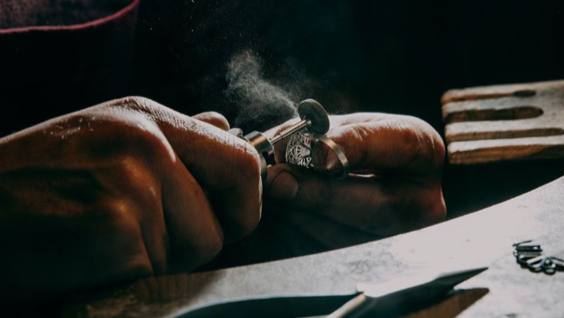 A jeweler making silver rings